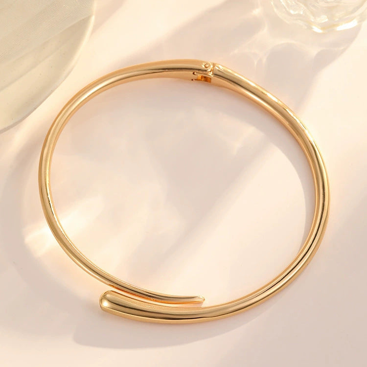 AVESSAE Sculptural Teardrop Collar Necklace in gold flat lay
